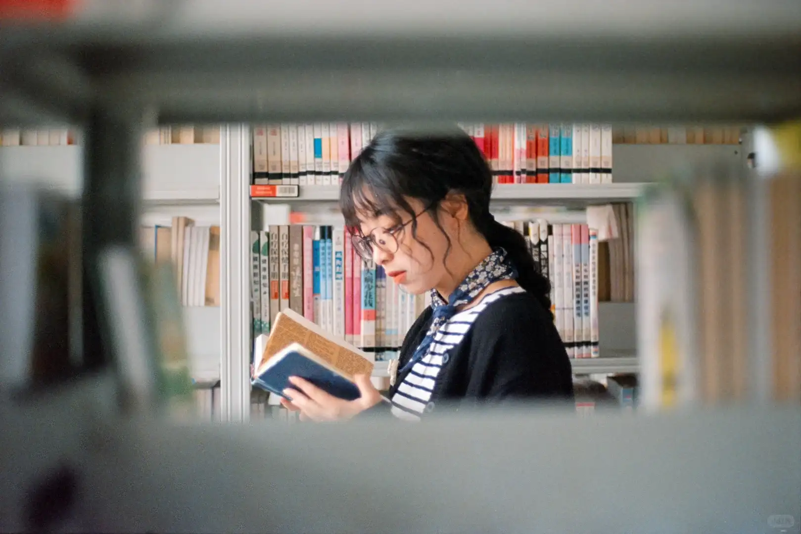 看书（透过书架拍，增加氛围感）